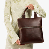 Coldbrew Small | Model wearing a convertible tote clutch crossbody