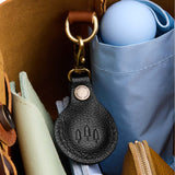 Pebbled--black | Round leather AirTag holder with snap closure and swivel lobster claw clasp