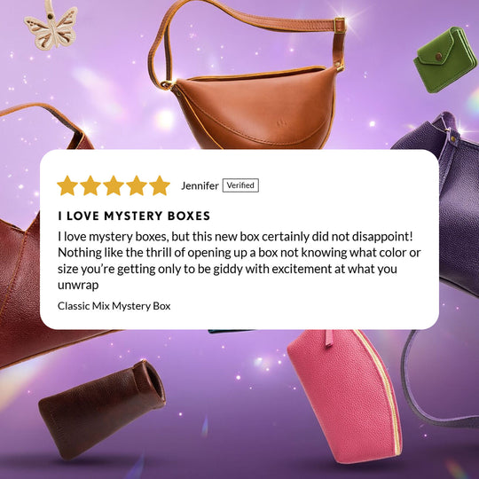 A promotional graphic for a mystery box featuring several leather handbags and small pouches on a purple sparkly background, with a large review card in the center.