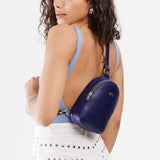 Cobalt | Model wearing small sling bag with zipper closure and adjustable strap