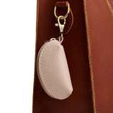 Oatmilk | Taco shaped leather pouch with zipper and swivel lobster clasp on white background
