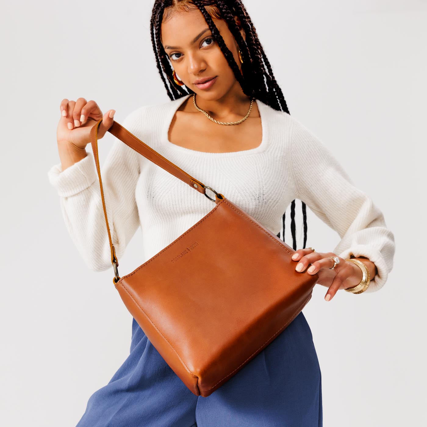 Honey*Classic | Model holding triangular shoulder bag with antiqued brass finished hardware
