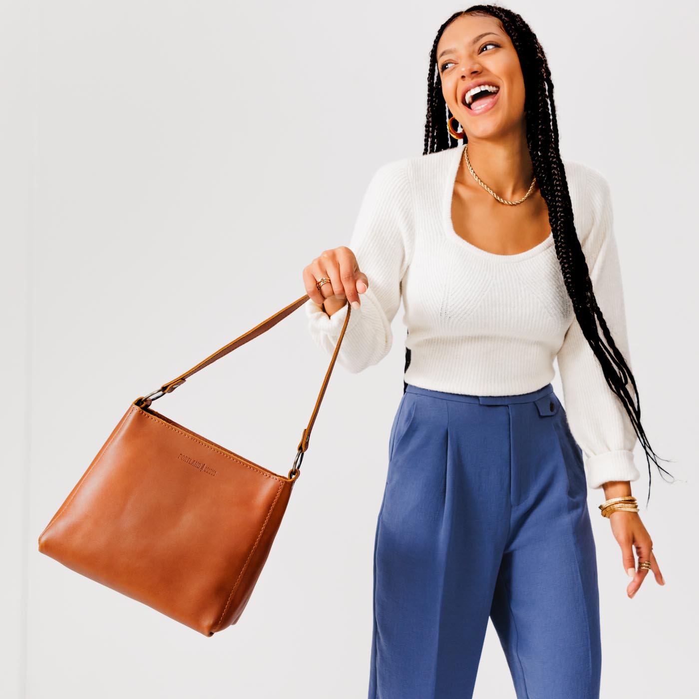 Honey*Classic | Model carrying triangular shoulder bag with antiqued brass finished hardware