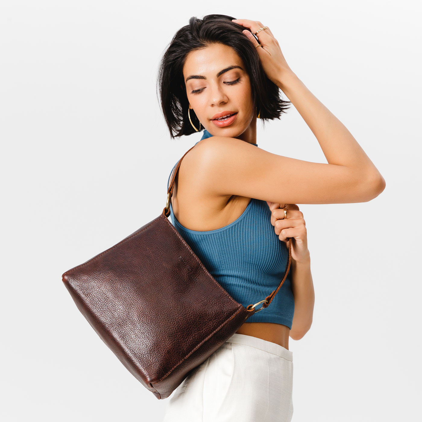 Coldbrew*Classic | Model carrying triangular shoulder bag with antiqued brass finished hardware