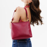 Berry Good Classic | Model wearing triangular shoulder bag with antiqued brass finished hardware