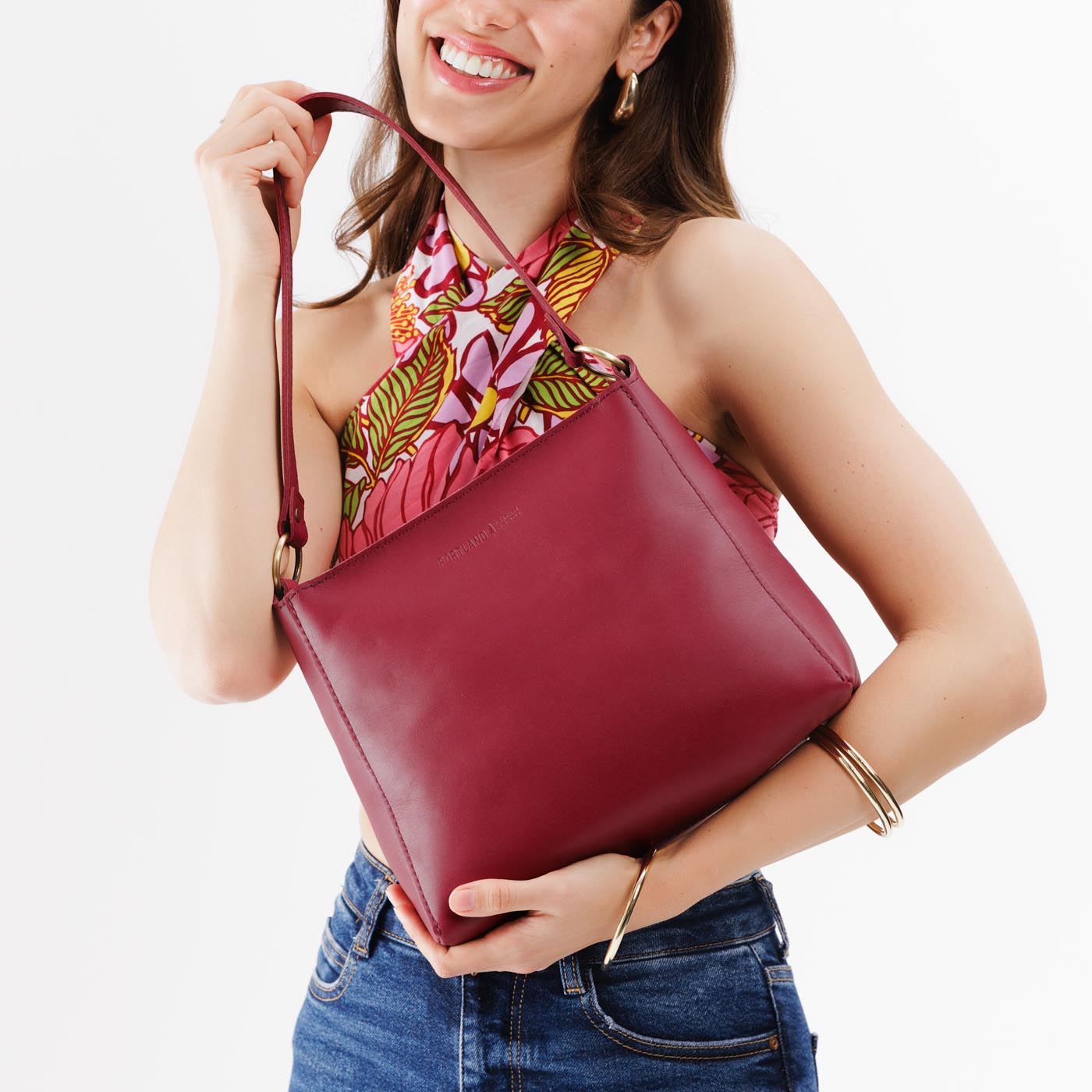 Berry Good*Classic | Model holding triangular shoulder bag with antiqued brass finished hardware