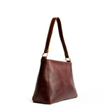 Cognac Classic | Triangular shoulder bag with antiqued brass finished hardware