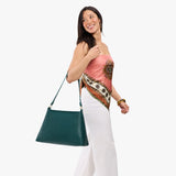 Sea Glass Large | Model carrying large triangular shoulder bag with antiqued brass finished hardware