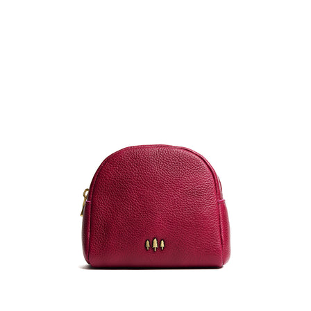 Orchid | Curved top leather pouch with zipper opening, flat base, and three metal tree emblems in front